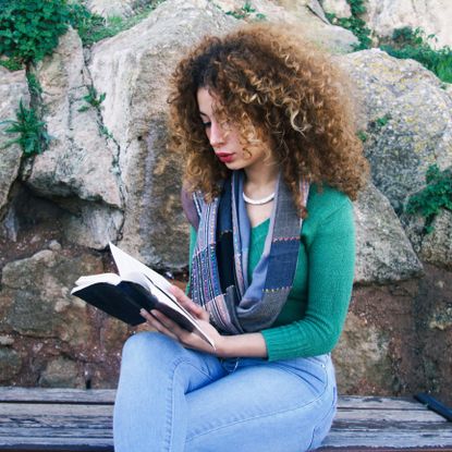 Human, Denim, Sitting, Rock, Ringlet, Street fashion, Reading, Bedrock, Jheri curl, Long hair, 