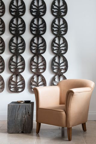 Metal lily pad wall hangings, log coffee table, beige armchair