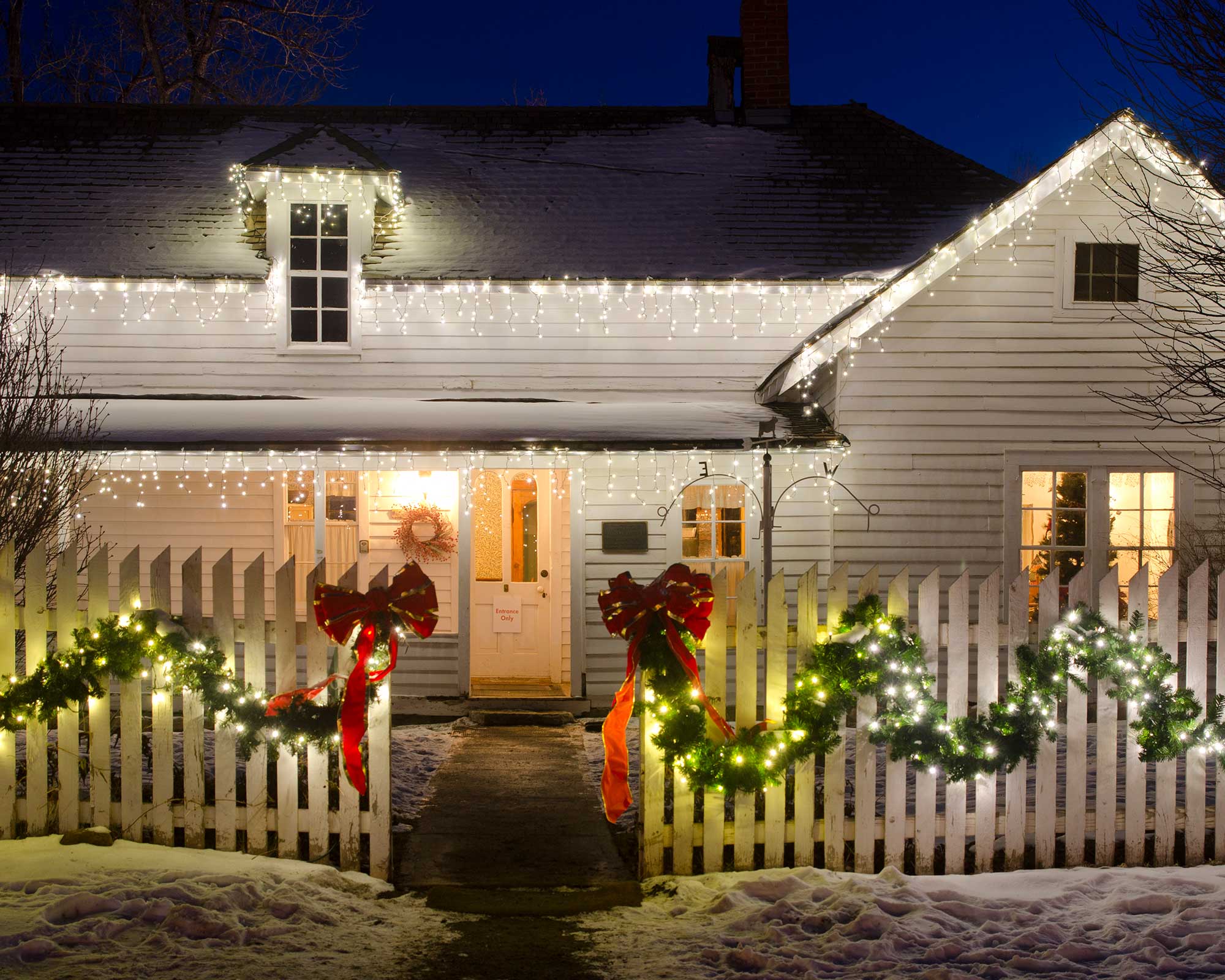 Christmas lights on house and fence