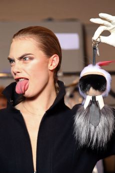 Cara Delevingne carried a Karl Lagerfeld doll in the Fendi show.