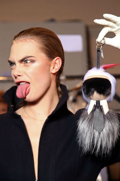 Cara Delevingne carried a Karl Lagerfeld doll in the Fendi show.