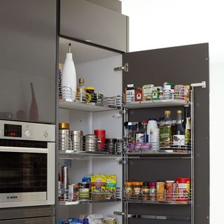 kitchen with oven and food items on shelves
