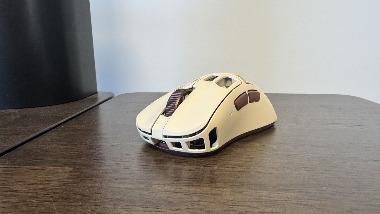 The Pulsar Feinmann F01 Noctua Edition gaming mouse from the front left on a wooden desk