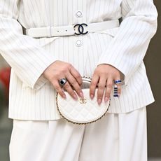 A close up of a woman's nails holding on to a chanel handbag - How to make your manicure last longer