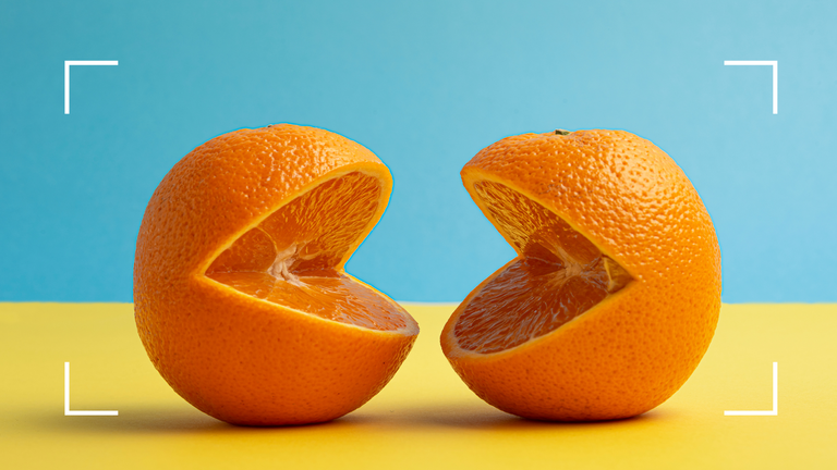 two open oranges mouth concept on blue and yellow background 