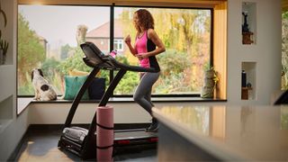 Woman running on the treadmill at home