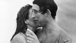 Prince Charles is kissed by Jane Priest, a model, as he emerges from the water at Cottesloe beach in Perth, during his 1979 tour of Australia.