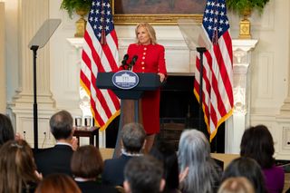 Jill Biden at the White House podium wearing a red schiaparelli custom suit