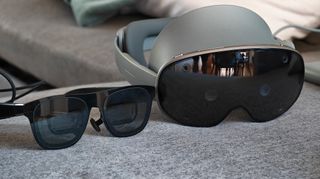 A pair of Xreal One Pro smart glasses next to a Samsung Galaxy XR headset