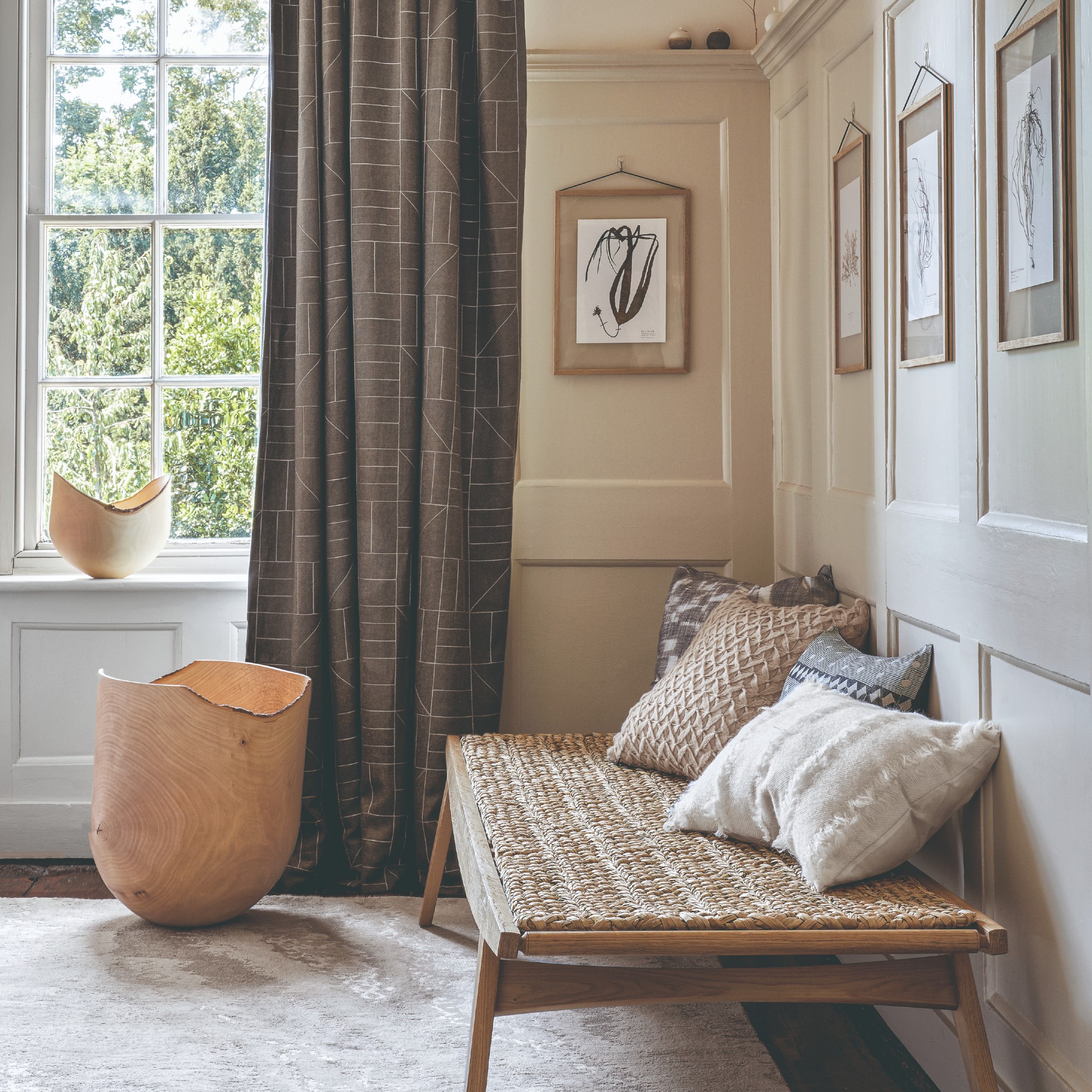 A neutral-coloured hallway with a woven bench and wall panelling