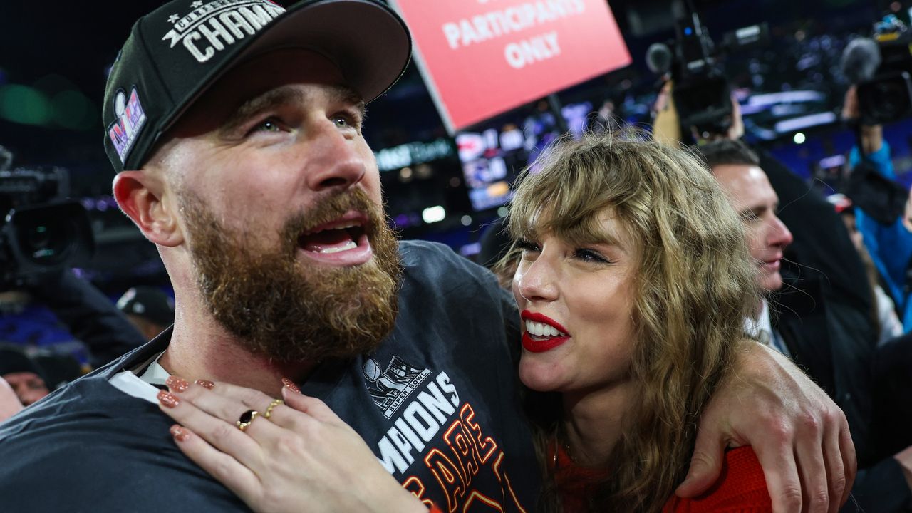 Travis Kelce #87 of the Kansas City Chiefs (L) celebrates with Taylor Swift after defeating the Baltimore Ravens in the AFC Championship.