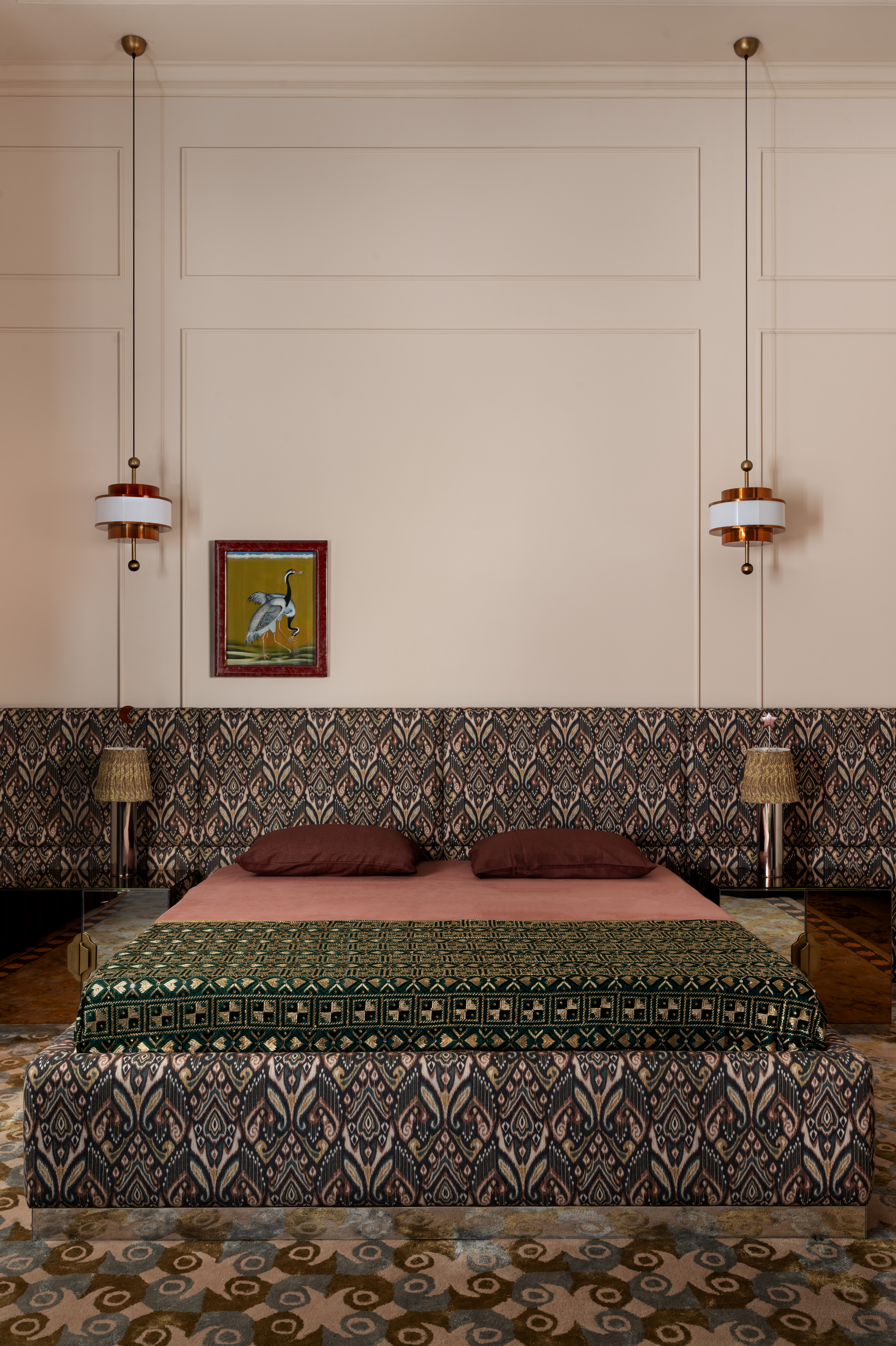 A bed with myriad patterns across the frame, rug, walls and covers