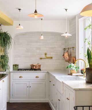 Pot filler taps trend, brassy colored tap by deVOL in marble kitchen