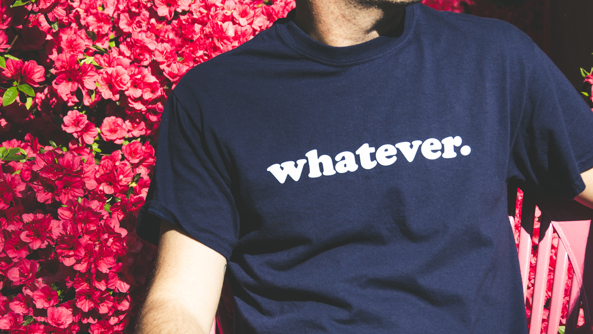 person with t-shirt that says 'whatever' on it