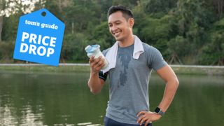 Man about to drink a protein shake after an outdoor workout