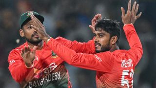 Bangladesh's Mehidy Hasan Miraz celebrates with his captain Najmul Hossain Shanto (L) after taking the wicket of India's Sanju Samson ahead of the India vs Bangladesh 2nd T20 2024 live stream