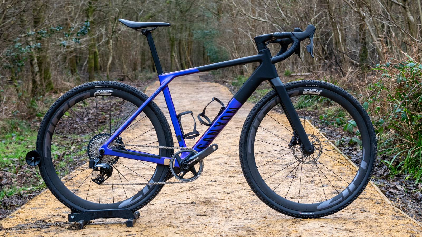 A purple and black Canyon Grail CF SLX in woodland