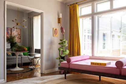 a colorful living room with yellow curtains