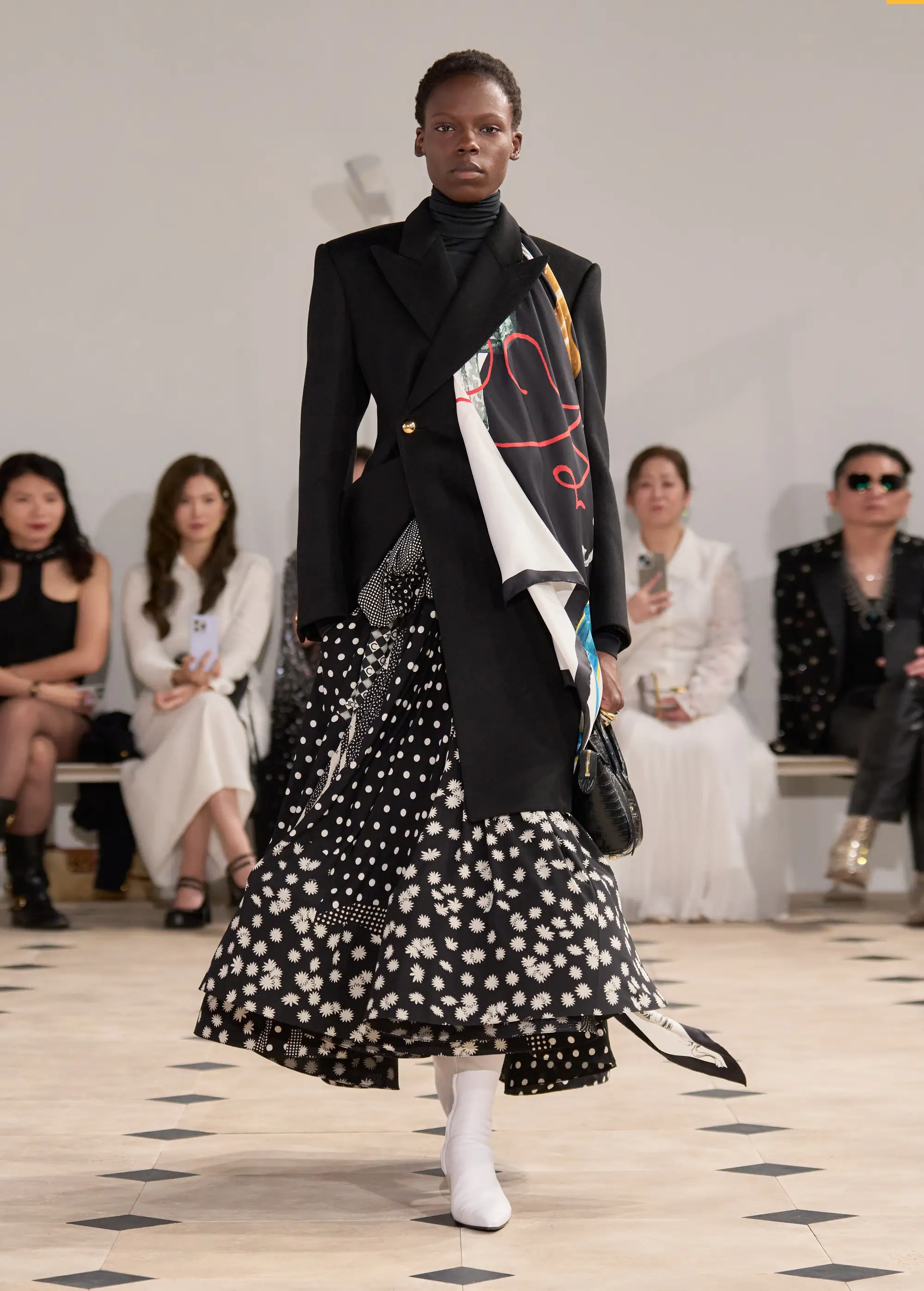 Scarves are tucked into necklines on the Celine SS'26 runway;