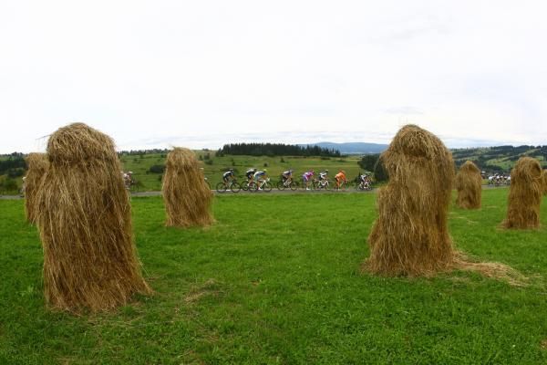 Piles of hay look like small, hairy monsters as the peloton passes