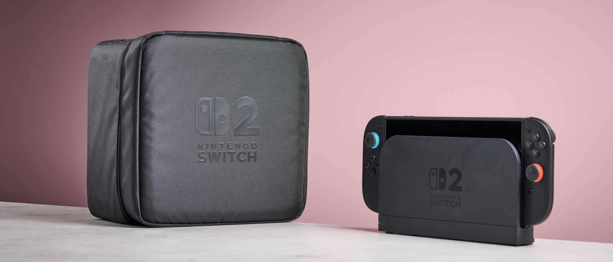 Nintendo Switch 2 All-In-One Carrying Case next to a docked Nintendo Switch 2 console