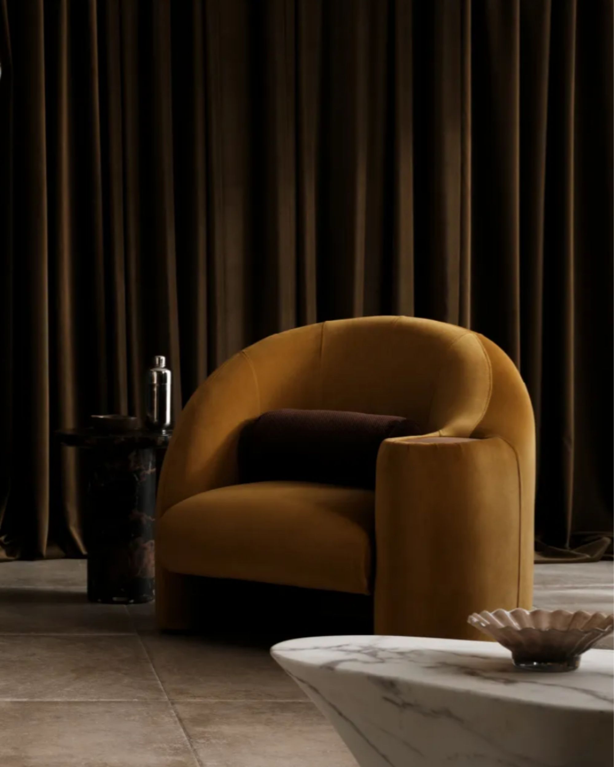 image of an ochre yellow accent chair in a dark room.