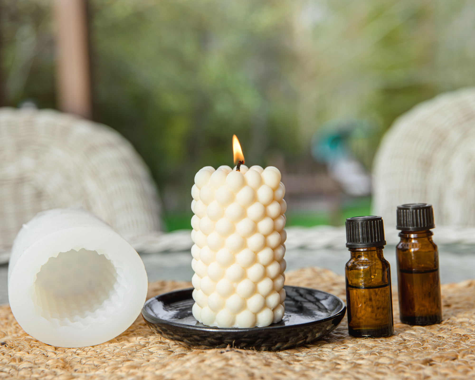 Citronella candle and essential oils on table