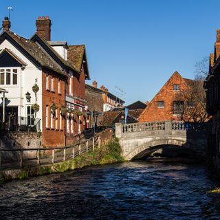 exterior of houses with river and bridge