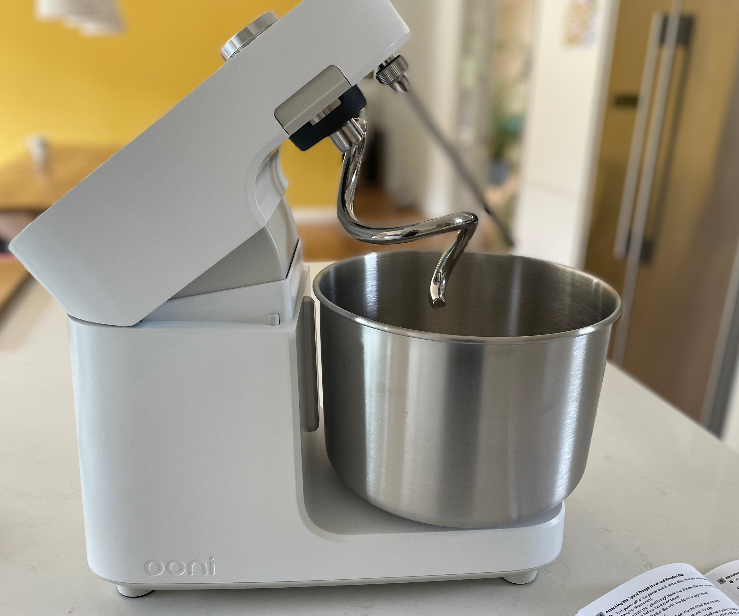 The Polar White Ooni Halo Pro Spiral Mixer, tiled upwards to display the spiral dough attachment