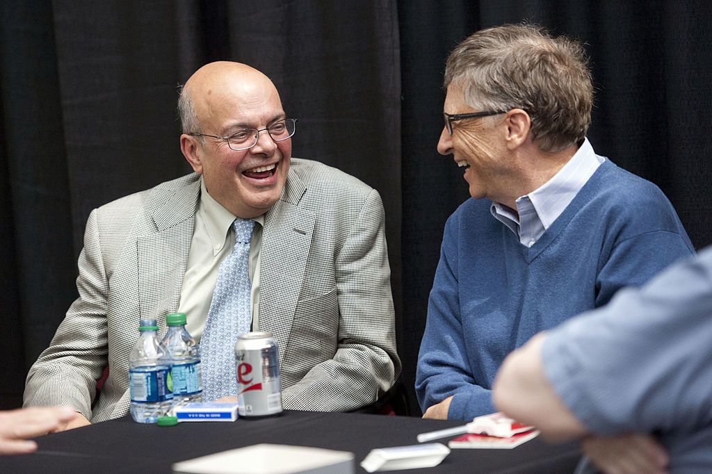 Ajit Jain, head of the Berkshire Hathaway reinsurance business, left, talks with Bill Gates