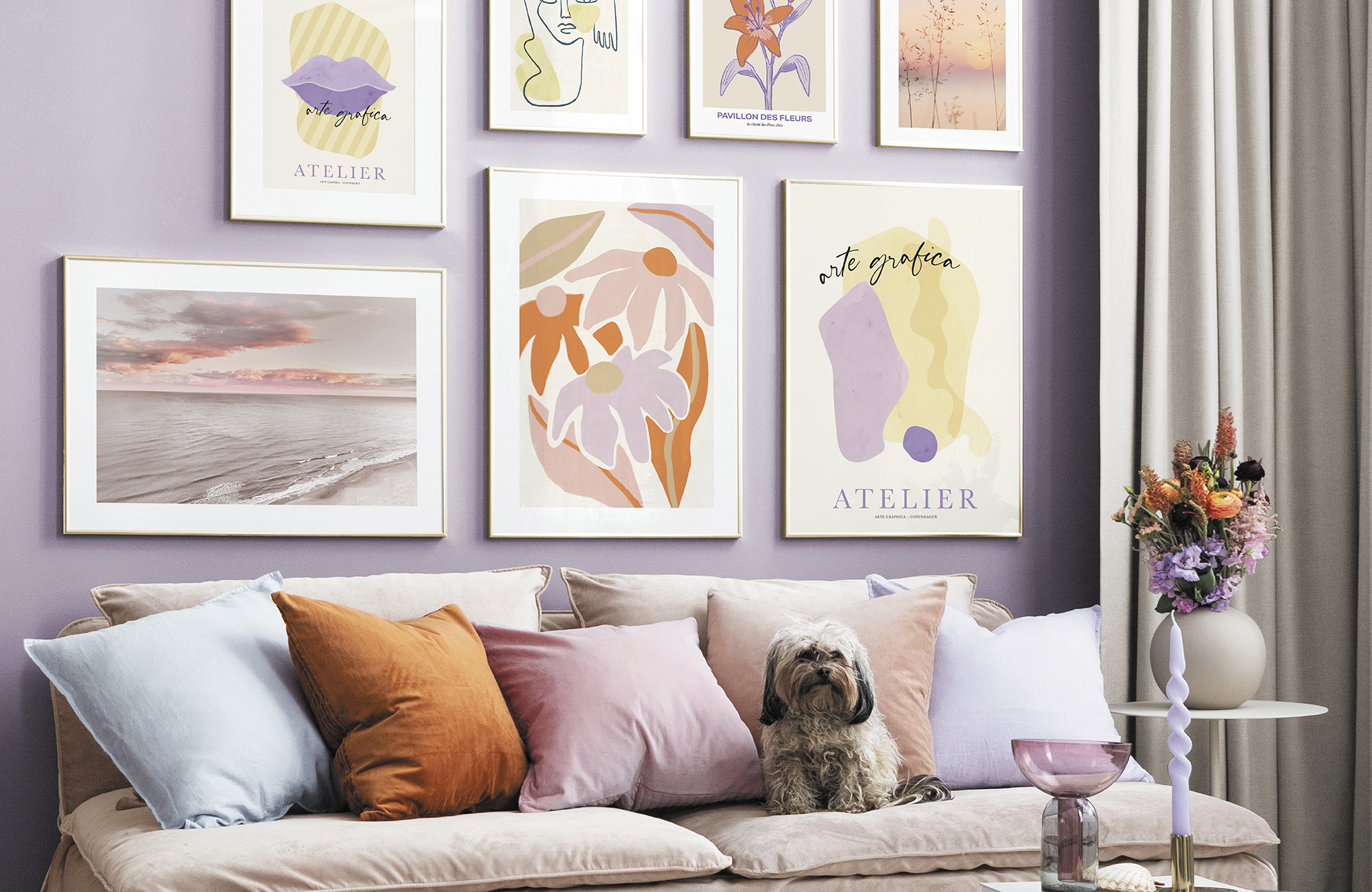 A modern living room idea by Desenio with pastel-themed gallery wall and cushions on sofa