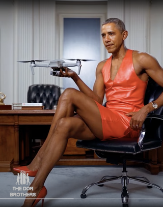 Dor Brothers Barak Obama holding a drone and wearing a dress fake