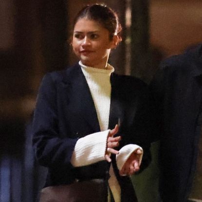 Zendaya on the set of her new movie wearing a cream sweater