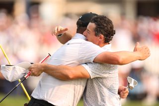 Michael Block and Rory McIlroy hug on the 18th green