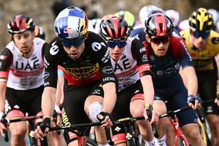 Team Jumbo&#039;s Wout van Aert of Belgium (Front L0 and Team UAE Emirates&#039; Tadej Pogacar of Slovenia (Rear C) ride in the ascent of Cipressa during the 113th Milan-San Remo one-day classic cycling race, on March 19, 2022 between Milan and San Remo, northern Italy. (Photo by Marco BERTORELLO / POOL / AFP)