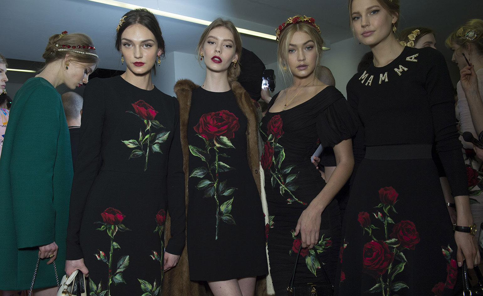 Models wearing black dresses with floral prints and golden hairpiece elements, from Dolce & Gabbana A/W 2015 collection.
