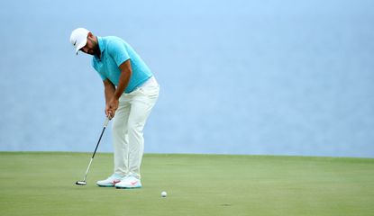 Alex Levy strikes a putt on the green
