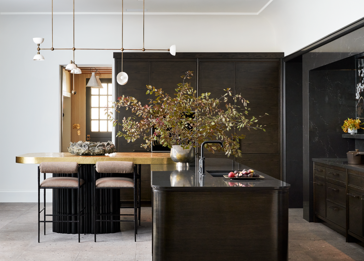 A large kitchen with an island extending out to an eating space