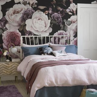 master bedroom with punch with wallpapered feature wall floral design clamping colour scheming of pink and navy blue