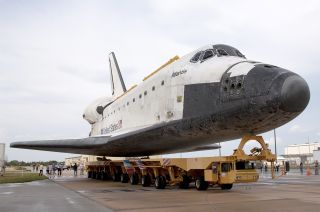 Space shuttle Atlantis moving atop the Orbiter Transporter System (OTS) at NASA's Kennedy Space Center in Florida.