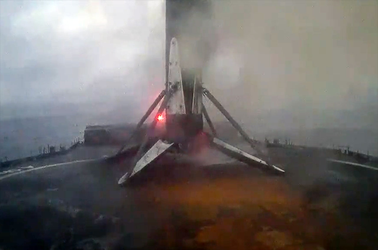 A SpaceX Falcon 9 rocket's first stage is seen after touching down on the droneship 