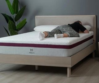 A woman lying on the Helix Dusk Mattress.