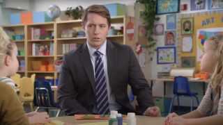 Beck Bennett sits at a table of children in AT&T.