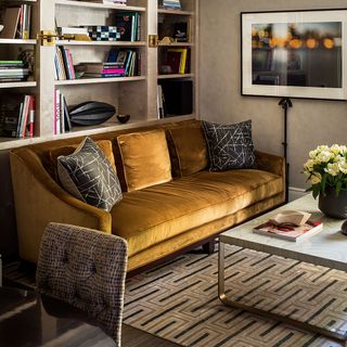 family room with mustered yellow sofa and rug