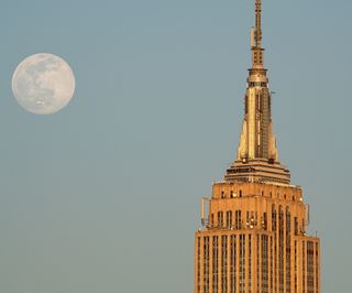 An airplane "photobombs" the nearly-full Worm Moon above the Empire State Building in New York City, on March 8, 2020.