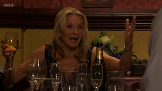 Kathy Beale getting drunk at the Vic surrounded by empty glasses