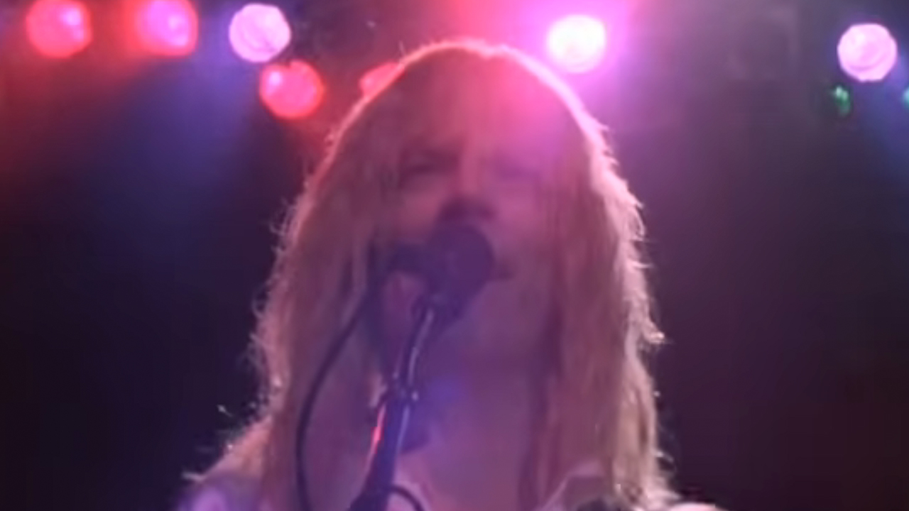 A close up of Michael McKeon singing into a microphone in This Is Spinal Tap