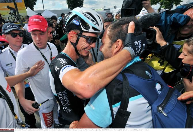 Tony Martin celebrates a rare road win with Achim Schmiedel