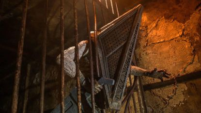 Pyramid Head crashing through iron bars in Return to Silent Hill