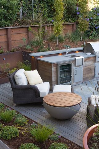 Decked area with outdoor kitchen and dining area